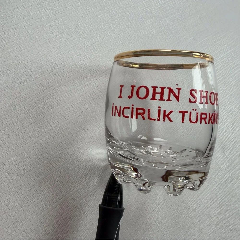 VTG I John Shop in‎ Incirlik, Türkiye shot glass in a gold rim & bold red text
